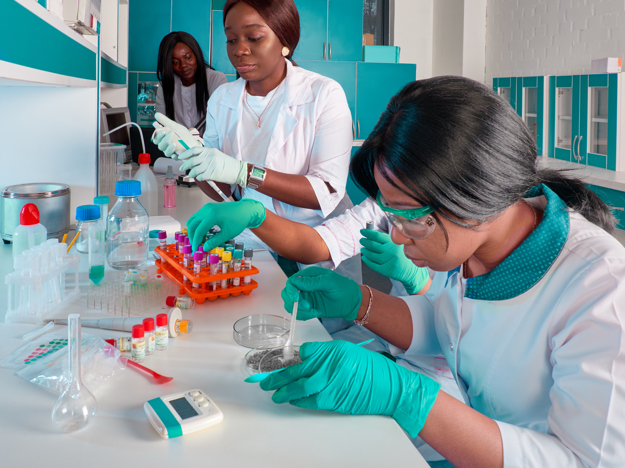African medical students, scientists, young women working in research laboratory, medical test lab. Quality control of various substances. Laboratory environment. Basic research in biology, chemistry