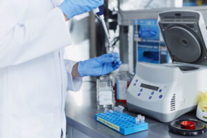 Scientist pipetting samples into eppendorf tubes before doing centrifugation