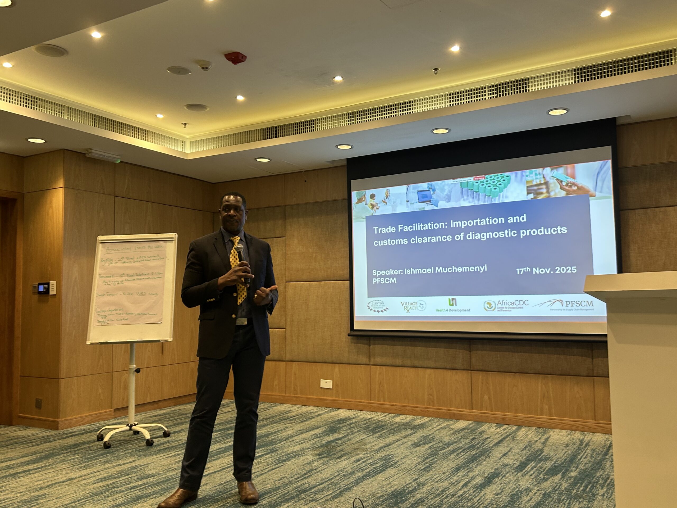 Ishmael Muchemenyi presenting on trade facilitation and customs clearance of diagnostic products at the GHSC 2025 workshop in Kigali